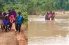 Khabar East:Villagers-carried-a-pregnant-woman-writhing-in-labor-pain-across-the-river-to-the-hospital